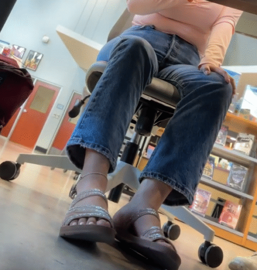 Latina Girl in Sandals while talking to friend