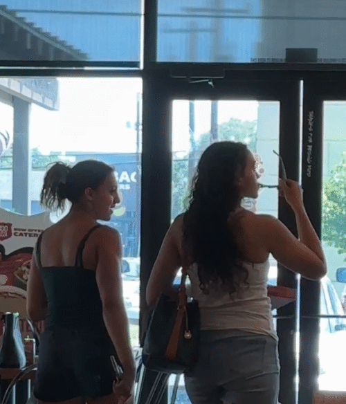 Two Pretty Girls Take Off their Sandals at Diner - Image 2